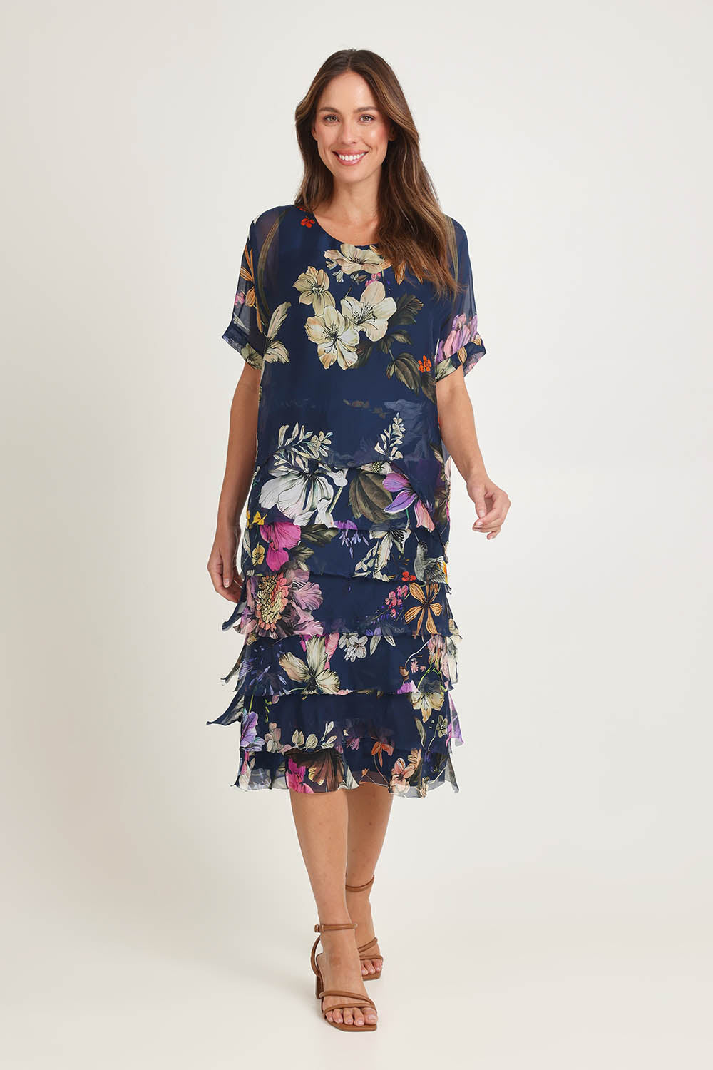 Model Madeline wearing the Silk Blend Multi Layer Print Dress in colour Navyfloral (Blue), from the front, showing the whole outfit