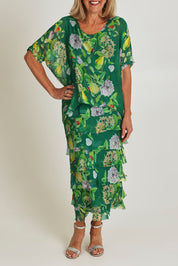 Model Sandy wearing size S of the Overlay Silk Print Dress in colour Greenflora (Green), from the front, cropped image