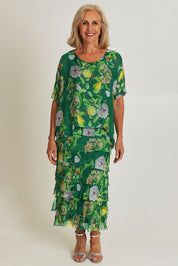 Model Sandy wearing size S of the Overlay Silk Print Dress in colour Greenflora (Green), from the front, showing the whole outfit