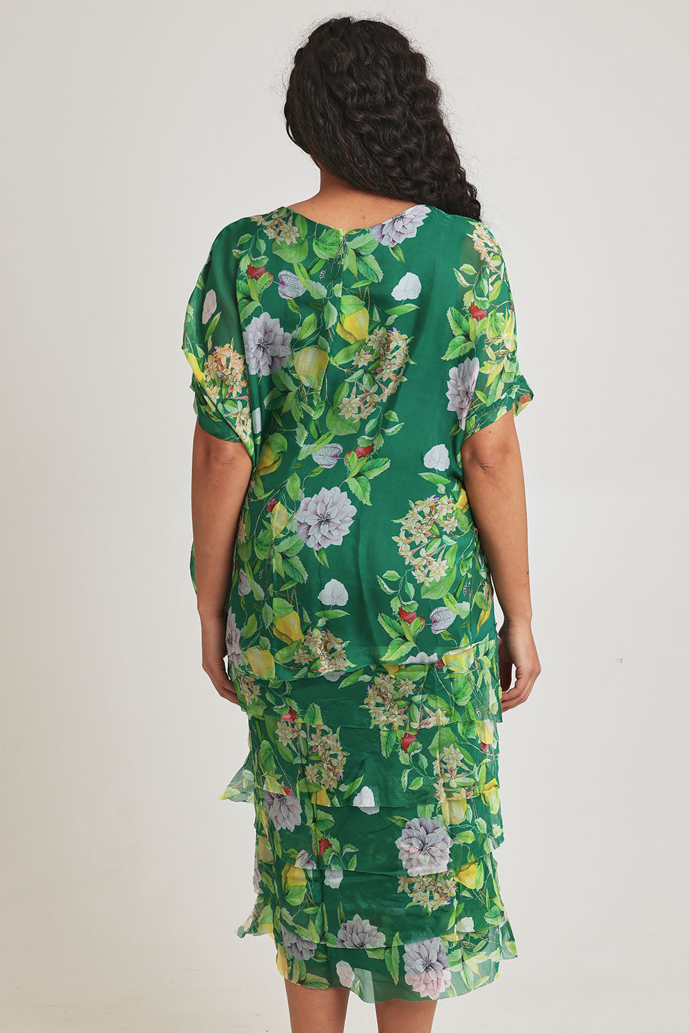 Model Terri-Leigh wearing size L of the Overlay Silk Print Dress in colour Greenflora (Green), from the back