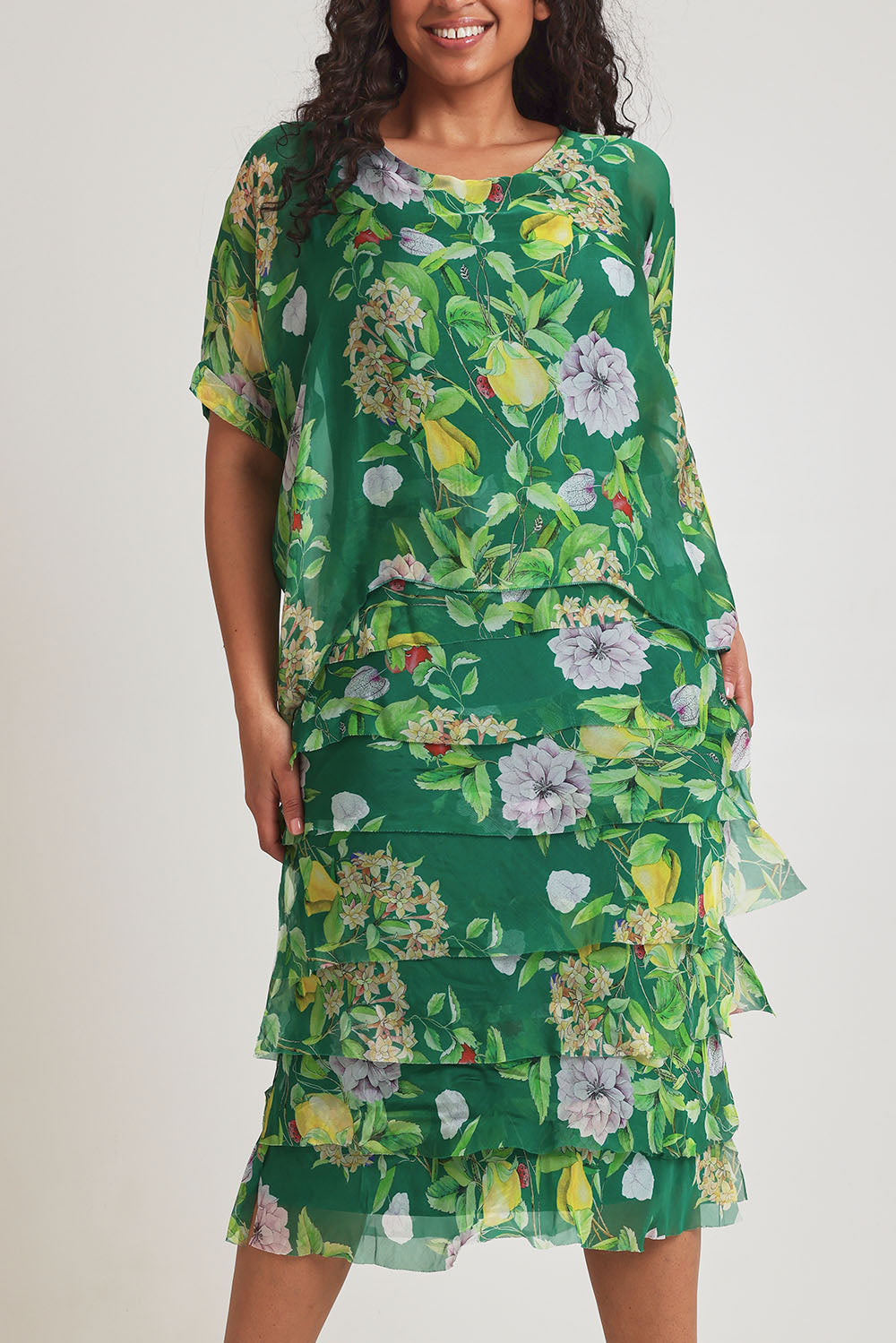 Model Terri-Leigh wearing size L of the Overlay Silk Print Dress in colour Greenflora (Green), from the front, cropped image