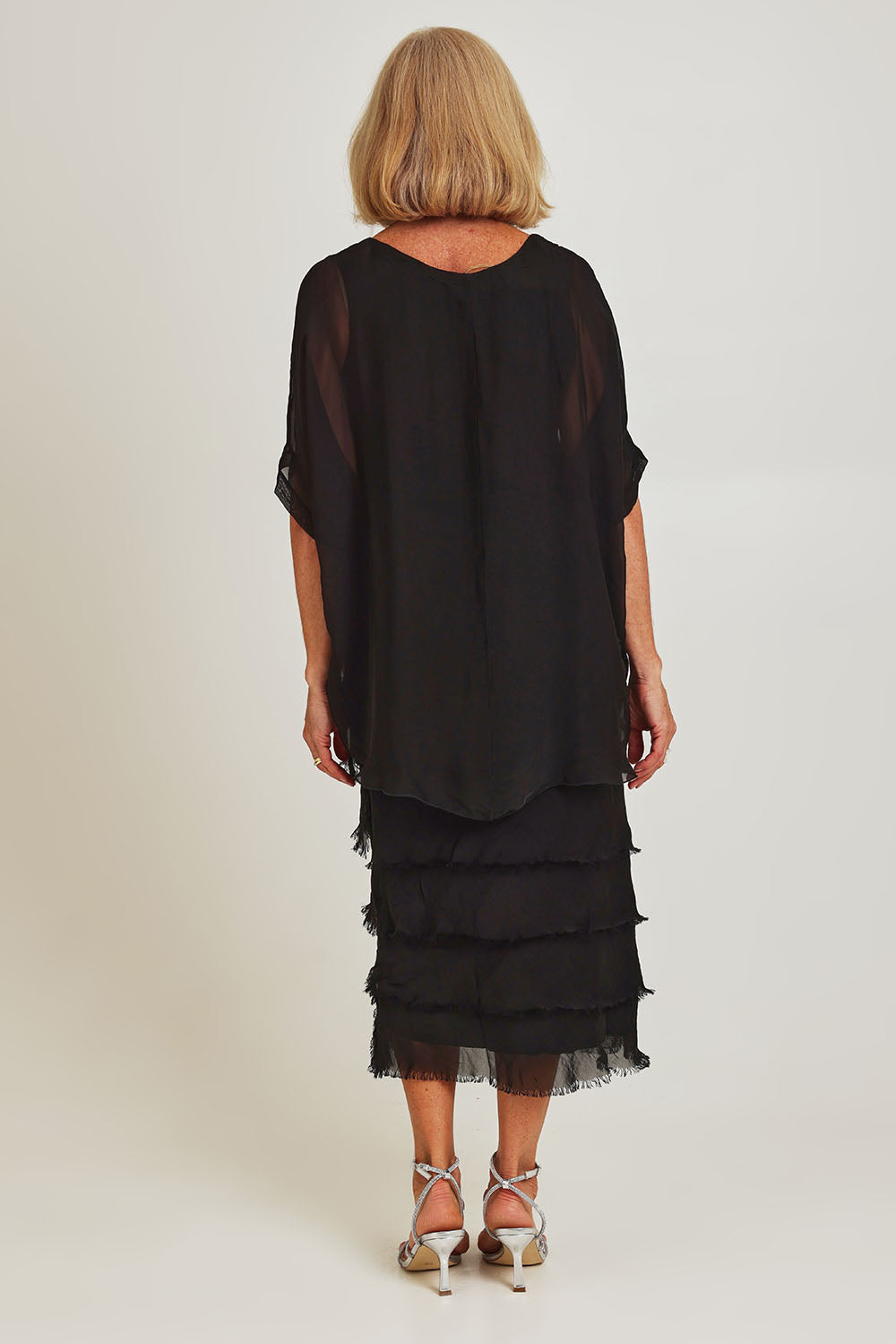 Model Sandy wearing the Silk Blend Multi Layers Dress in colour Black (Black), from the back