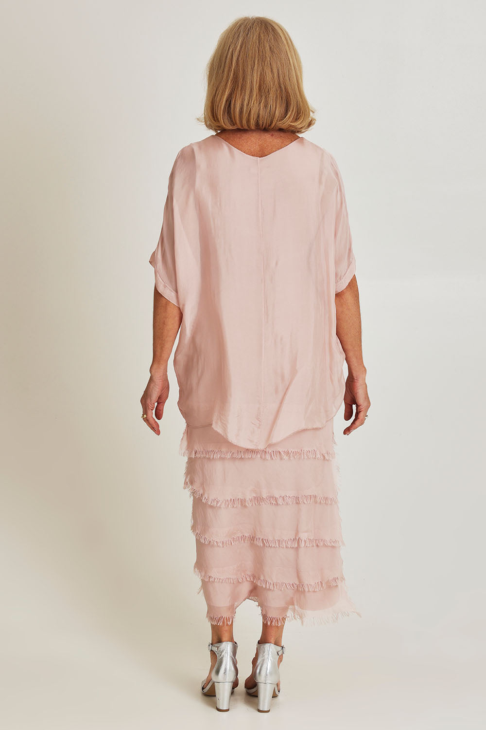 Model Sandy wearing the Silk Blend Multi Layers Dress in colour Blush (Pink), from the back