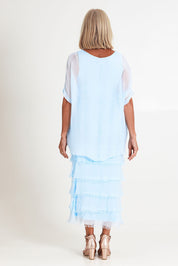 Model Sandy wearing the Silk Blend Multi Layers Dress in colour Celeste (Blue), from the back