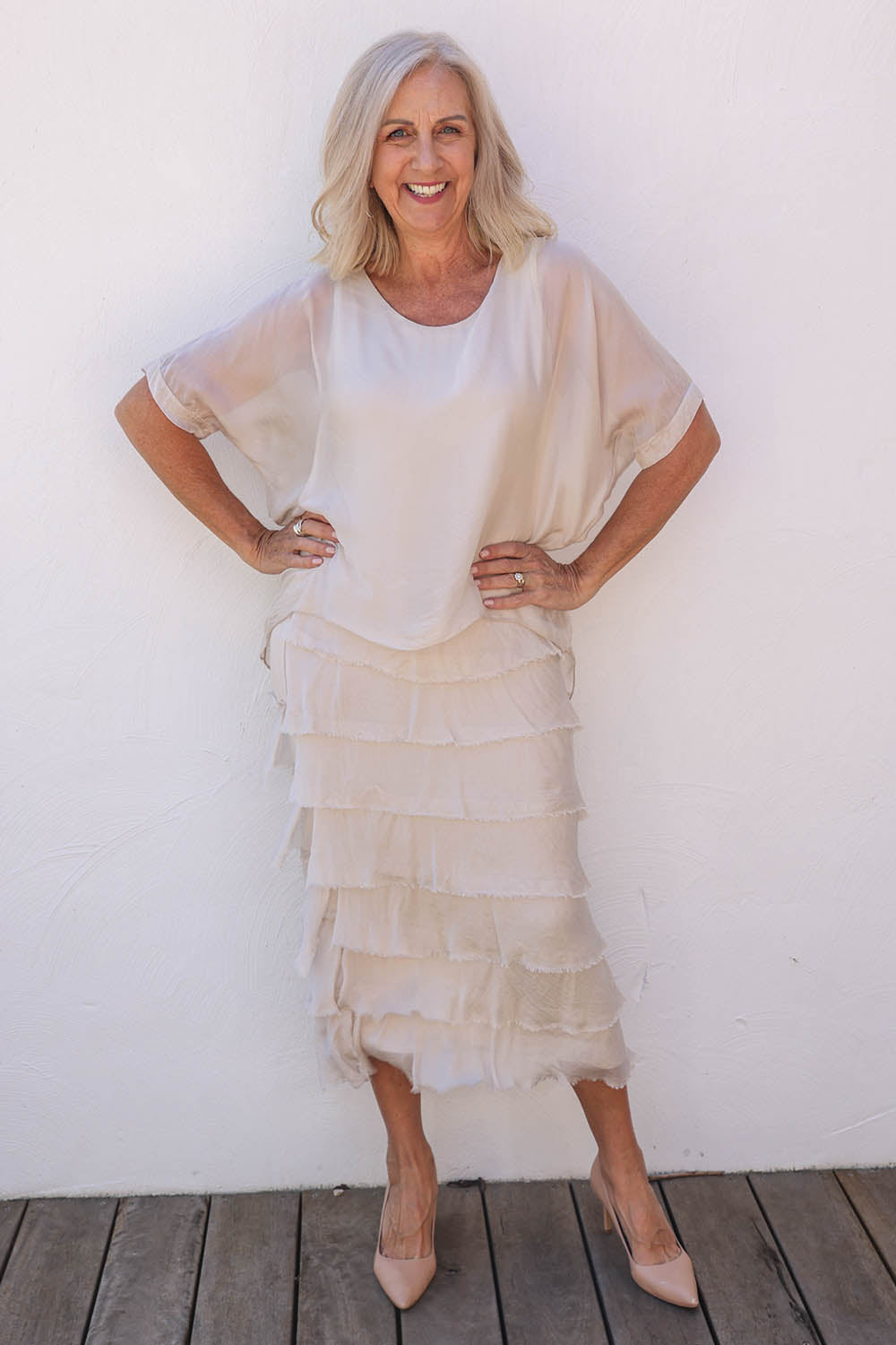 Model Sandy wearing the Silk Blend Multi Layers Dress in colour Champagne (White), from the front, showing the whole outfit