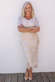 Model Sandy wearing the Silk Blend Multi Layers Dress in colour Champagne (White), from the front, showing the whole outfit