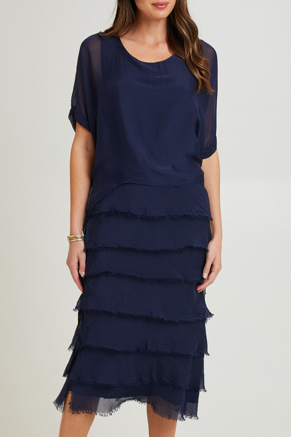 Model Madeline wearing the Silk Blend Multi Layers Dress in colour Navy (Blue), from the front, cropped image
