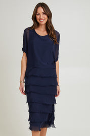 Model Madeline wearing the Silk Blend Multi Layers Dress in colour Navy (Blue), from the front, cropped image