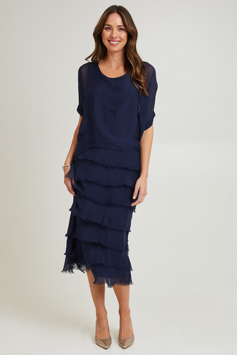 Model Madeline wearing the Silk Blend Multi Layers Dress in colour Navy (Blue), from the front, showing the whole outfit