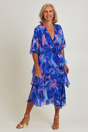 Model Sandy wearing the Short Sleeve Silk Print Dress in colour Cobaltpink (Blue), from the front, showing the whole outfit