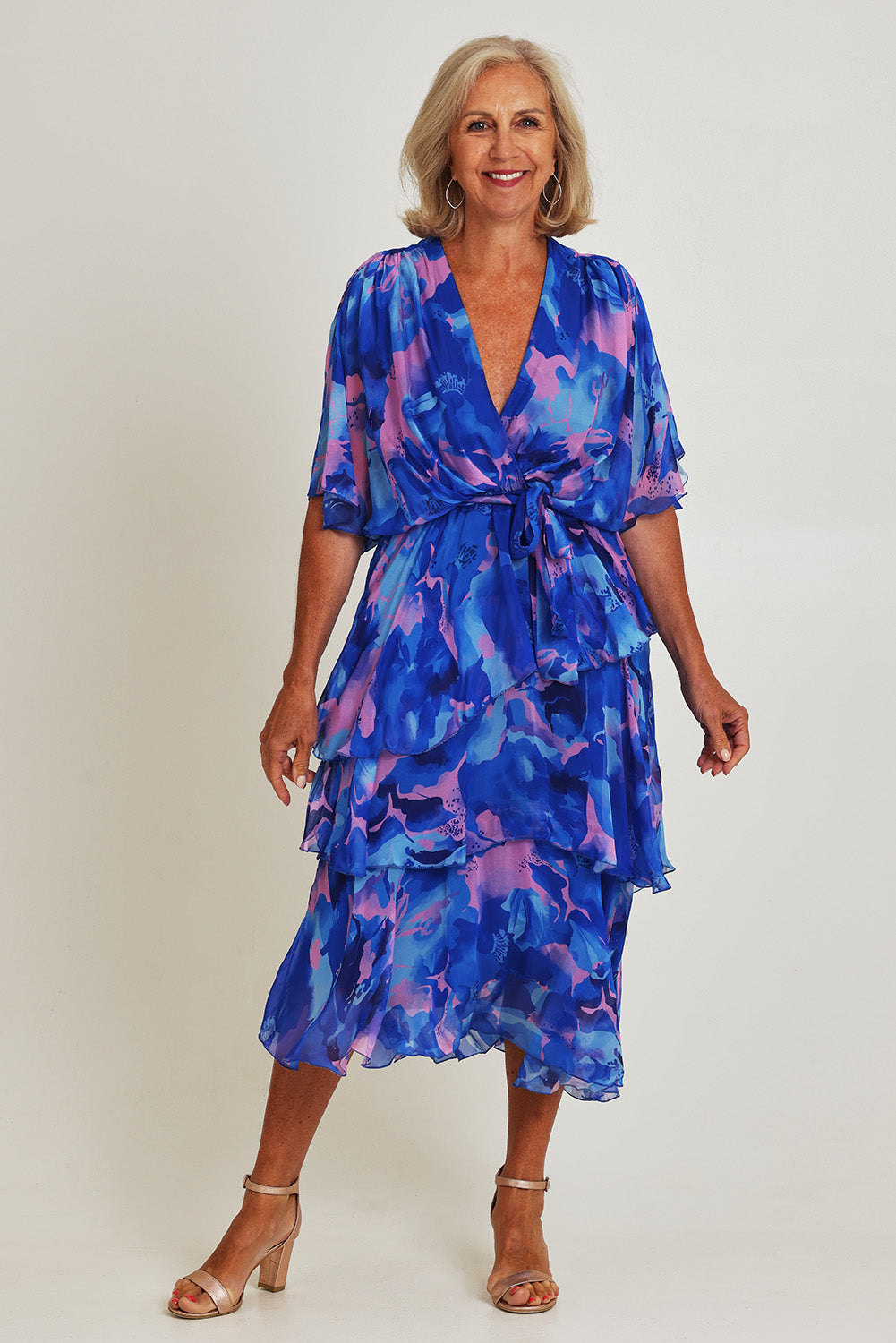 Model Sandy wearing the Short Sleeve Silk Print Dress in colour Cobaltpink (Blue), from the front, showing the whole outfit