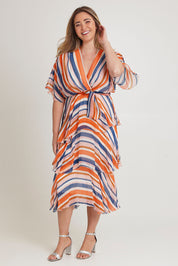 Model Chanel wearing the Short Sleeve Silk Print Dress in colour Orangenavy, from the front, showing the whole outfit