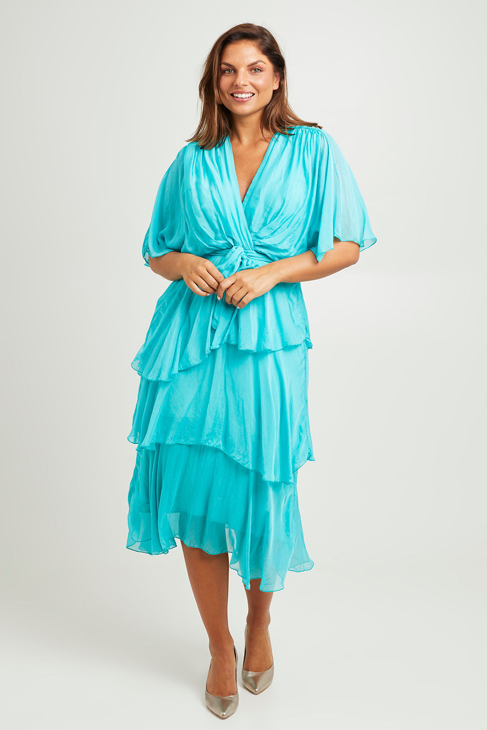 Model Monique wearing the Short Sleeve Silk Dress in colour Aqua (Green), from the front, showing the whole outfit