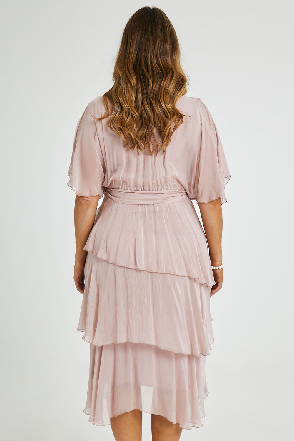 Model Laura wearing the Short Sleeve Silk Dress in colour Blushpink (Pink), from the back