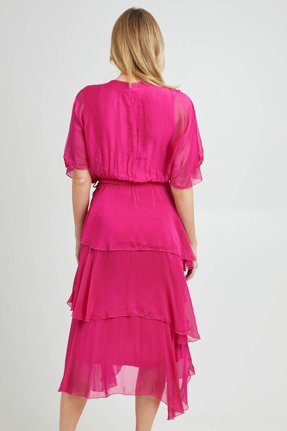 Model Grace wearing the Short Sleeve Silk Dress in colour Raspberry (Pink), from the back