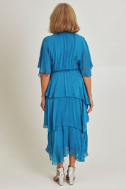 Model Sandy wearing the Short Sleeve Silk Dress in colour Teal (Blue), from the back