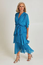 Model Sandy wearing the Short Sleeve Silk Dress in colour Teal (Blue), from the front, showing the whole outfit