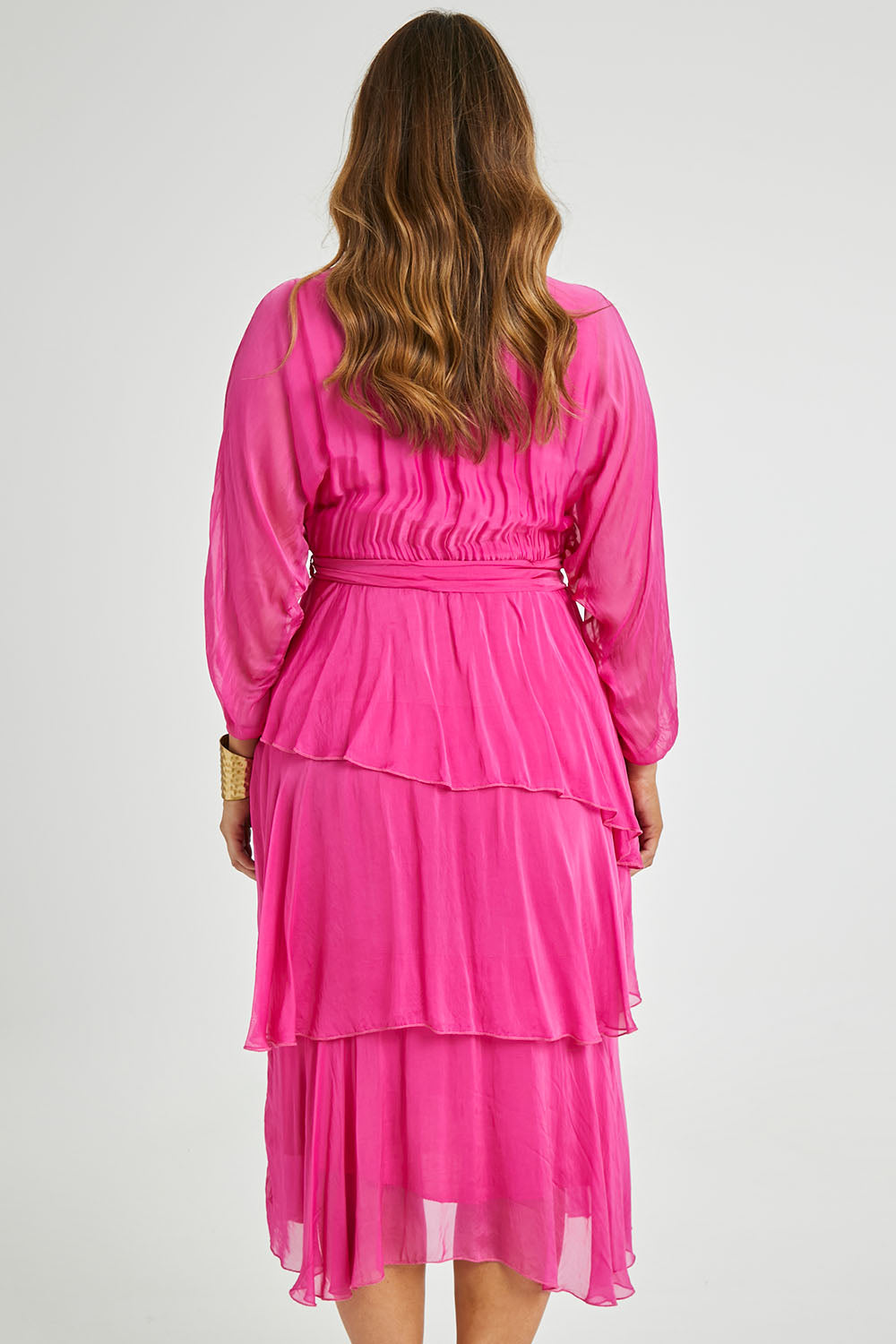 Model Laura wearing the Long Sleeve Silk Dress in colour Raspberry (Pink), from the back