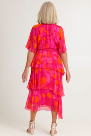 Model Sandy wearing the Short Sleeve Silk Blend Print Dress in colour Orangepink (Pink), from the back