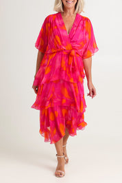 Model Sandy wearing the Short Sleeve Silk Blend Print Dress in colour Orangepink (Pink), from the front, cropped image