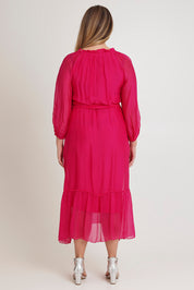 Model Chanel wearing the Long Sleeve Silk Frill Tied Neck Dress in colour Raspberry (Pink), from the back