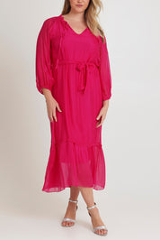 Model Chanel wearing the Long Sleeve Silk Frill Tied Neck Dress in colour Raspberry (Pink), from the front, cropped image