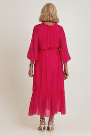 Model Sandy wearing the Long Sleeve Silk Frill Tied Neck Dress in colour Raspberry (Pink), from the back