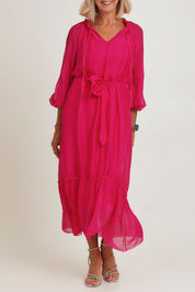 Model Sandy wearing the Long Sleeve Silk Frill Tied Neck Dress in colour Raspberry (Pink), from the front, cropped image