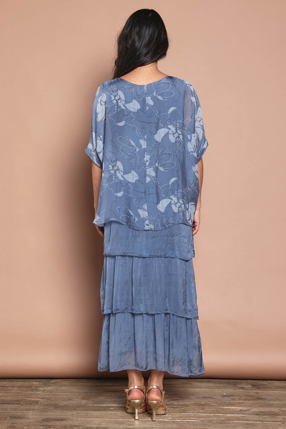 Model Katie wearing the Multi Layer Silk Blend Print Dress in colour Jeansprint (Blue), from the back