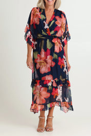 Model Sandy wearing the Frill Sleeve Silk Blend Print Dress in colour Navyprint (Blue), from the front, cropped image