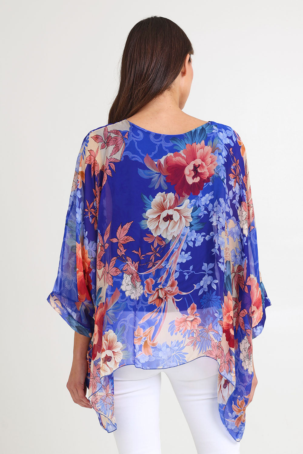 Model Madeline wearing the Silk Kaftan Top in colour Bluefloral (Blue), from the back