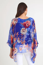 Model Madeline wearing the Silk Kaftan Top in colour Bluefloral (Blue), from the back