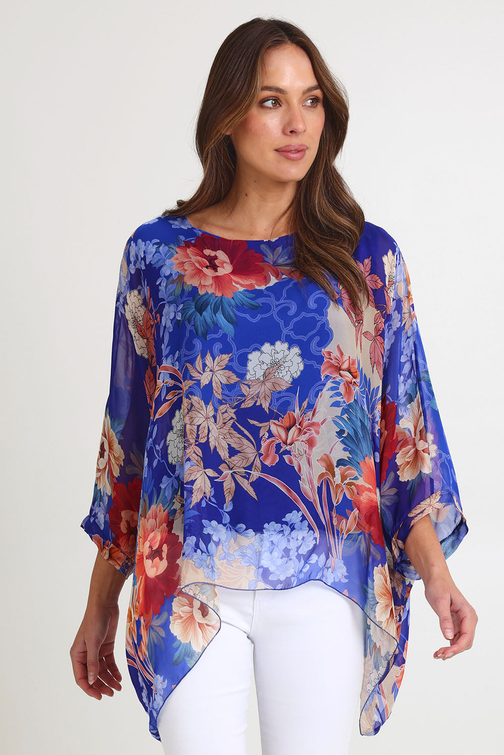 Model Madeline wearing the Silk Kaftan Top in colour Bluefloral (Blue), from the front, cropped image