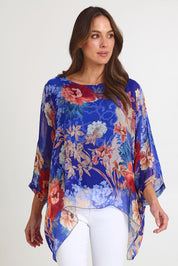 Model Madeline wearing the Silk Kaftan Top in colour Bluefloral (Blue), from the front, cropped image