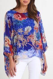 Model Madeline wearing the Silk Kaftan Top in colour Bluefloral (Blue), from the front, cropped image