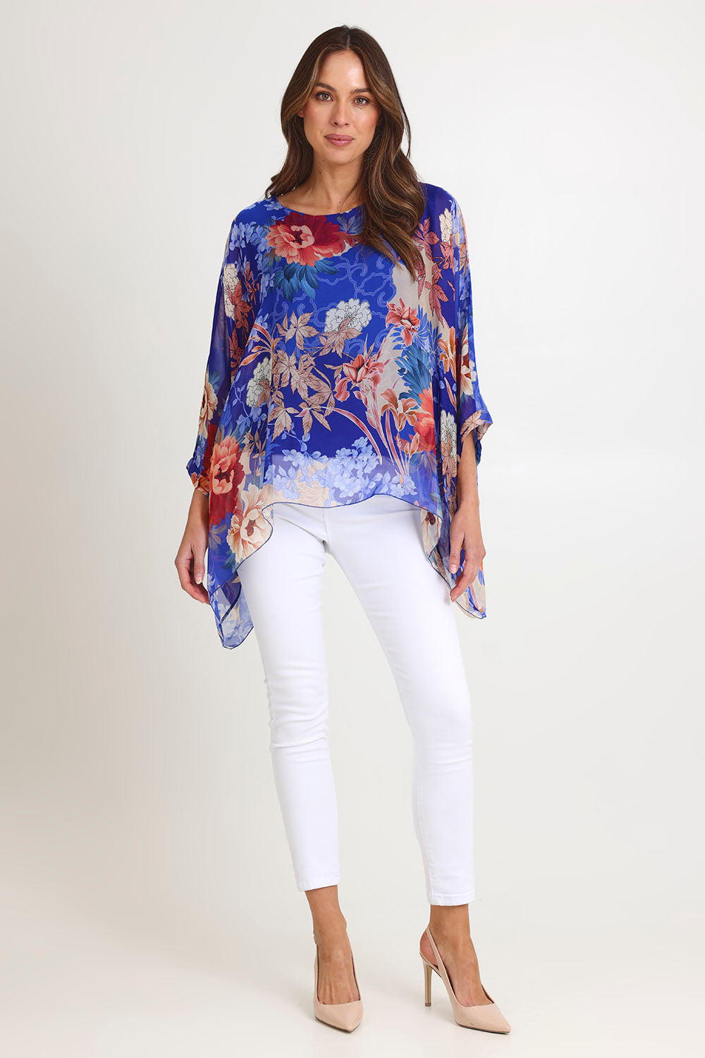 Model Madeline wearing the Silk Kaftan Top in colour Bluefloral (Blue), from the front, showing the whole outfit