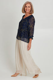 Model Sandy wearing the Silk Pant in colour Beige, from the front, showing the whole outfit