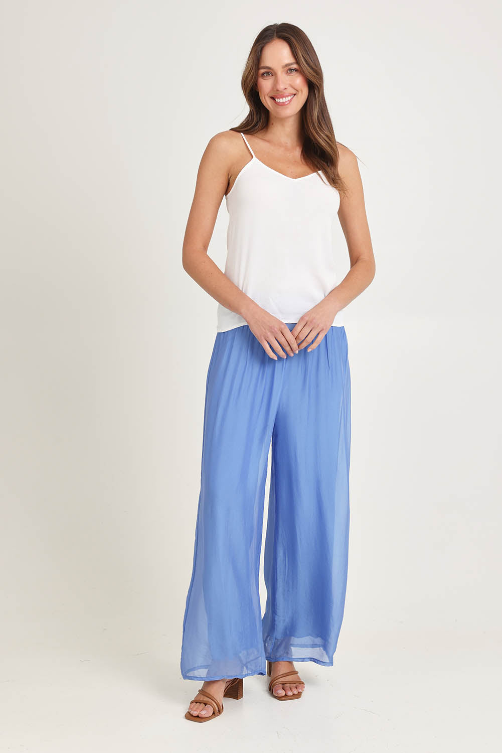 Model Madeline wearing the Silk Pant in colour Blueturco (Blue), from the front, showing the whole outfit