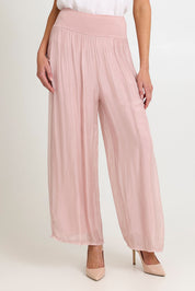 Model Madeline wearing the Silk Pant in colour BlushPink (Pink), from the front, cropped image