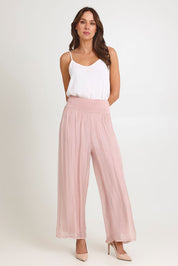 Model Madeline wearing the Silk Pant in colour BlushPink (Pink), from the front, showing the whole outfit