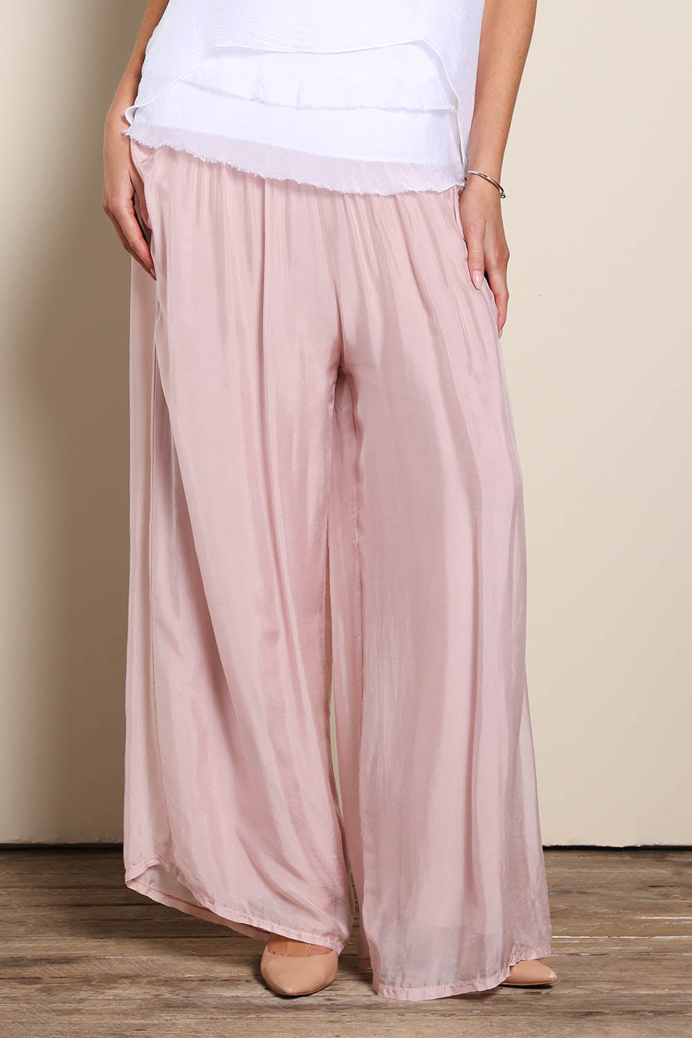 Model Maddiec wearing size 10 of the Silk Pant - BlushPink in colour BlushPink, in a cropped view