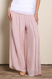 Model Maddiec wearing size 10 of the Silk Pant - BlushPink in colour BlushPink, in a cropped view