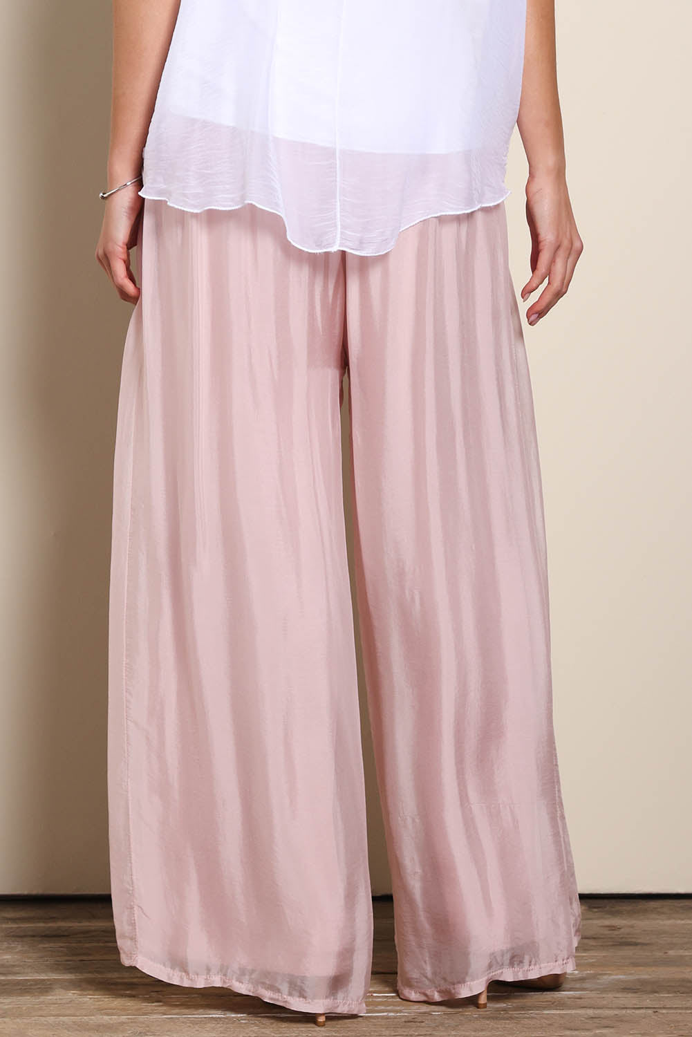 Model Maddiec wearing size 10 of the Silk Pant - BlushPink in colour BlushPink, in a cropped view