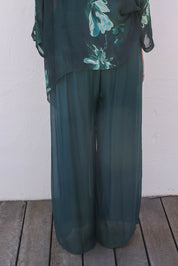 Model Sandy wearing the Silk Pant in colour Darkgreen (Green), from the back