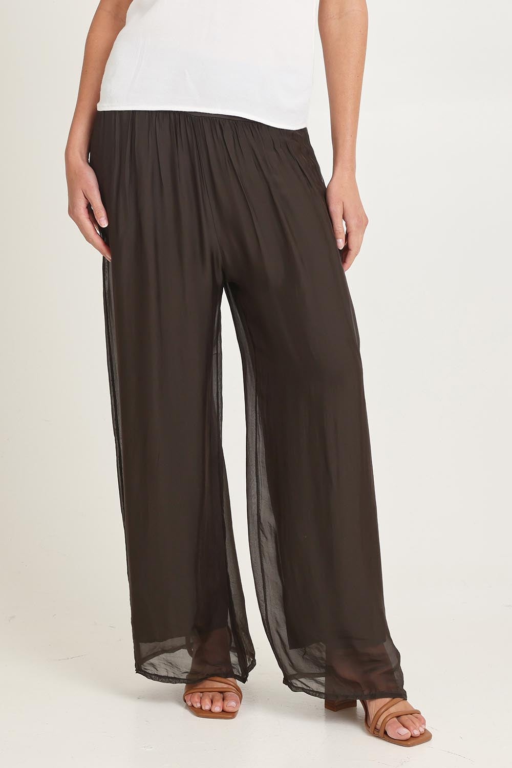 Model Madeline wearing the Silk Pant in colour Moro, from the front, cropped image