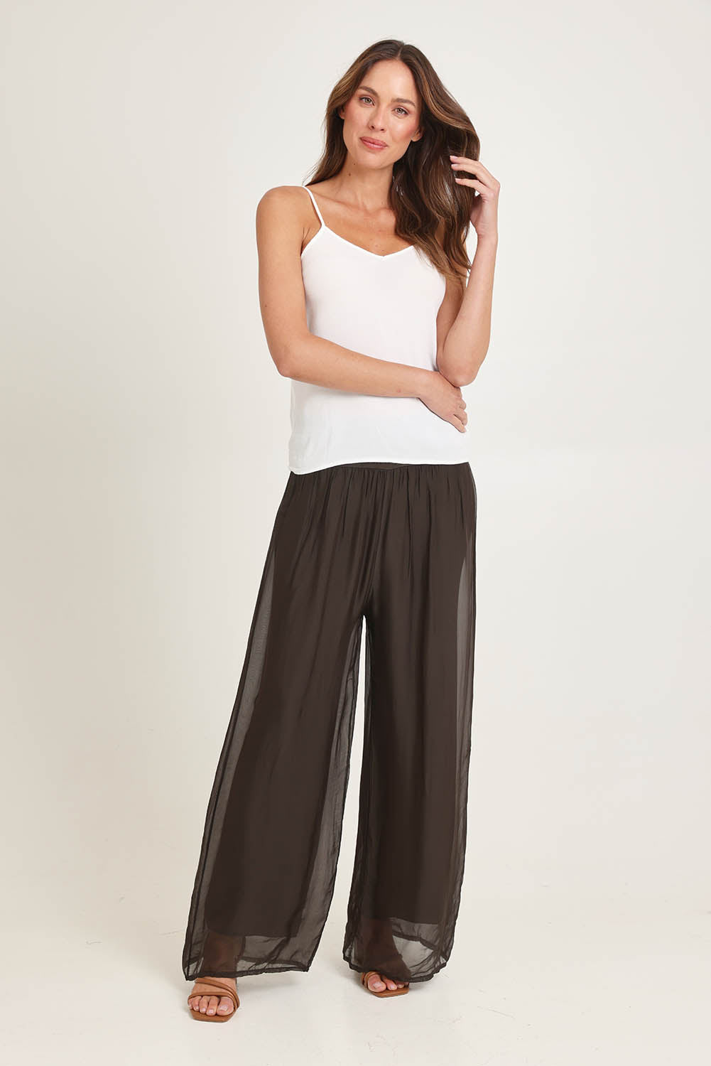 Model Madeline wearing the Silk Pant in colour Moro, from the front, showing the whole outfit