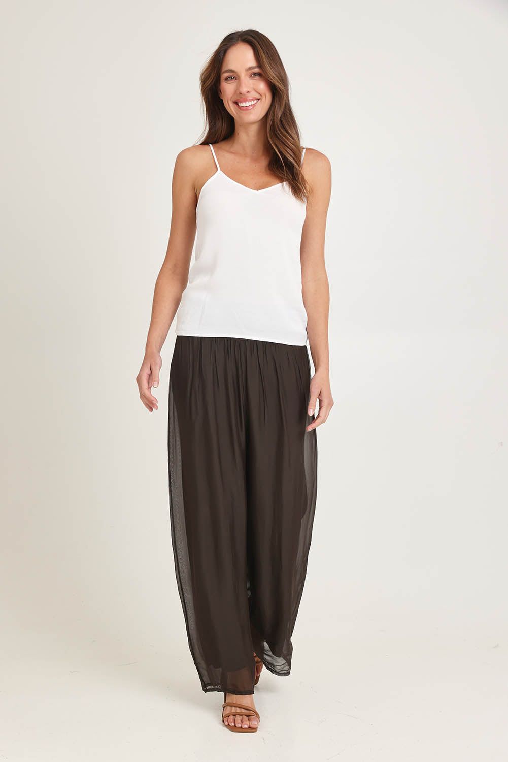 Model Madeline wearing the Silk Pant in colour Moro, from the front, showing the whole outfit