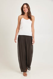 Model Madeline wearing the Silk Pant in colour Moro, from the front, showing the whole outfit