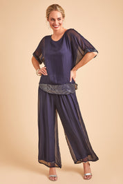 Model Grace wearing the Silk Pant in colour Navy (Blue), from the front, showing the whole outfit