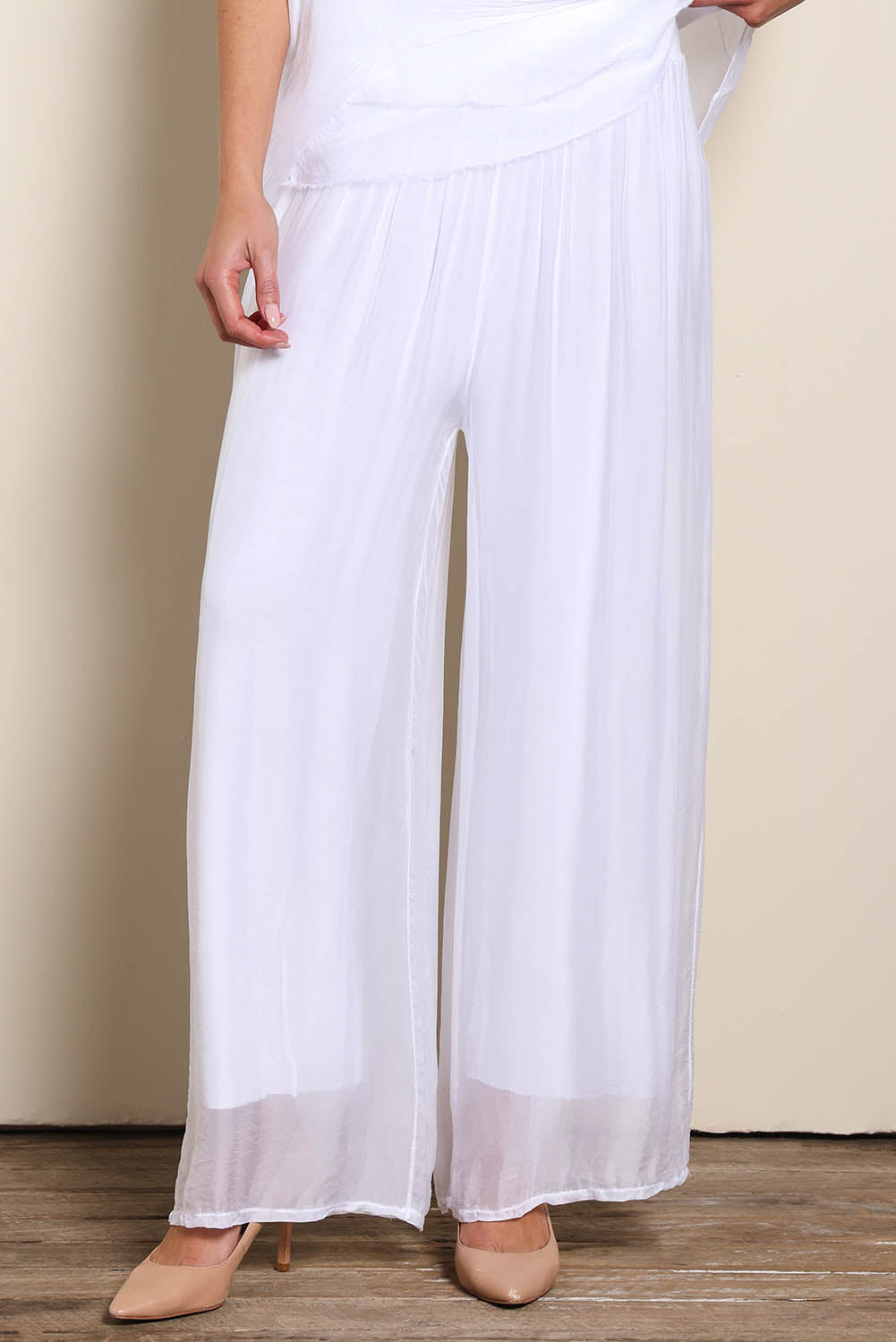 Model Maddiec wearing size 10 of the Silk Pant - White in colour White, in a cropped view